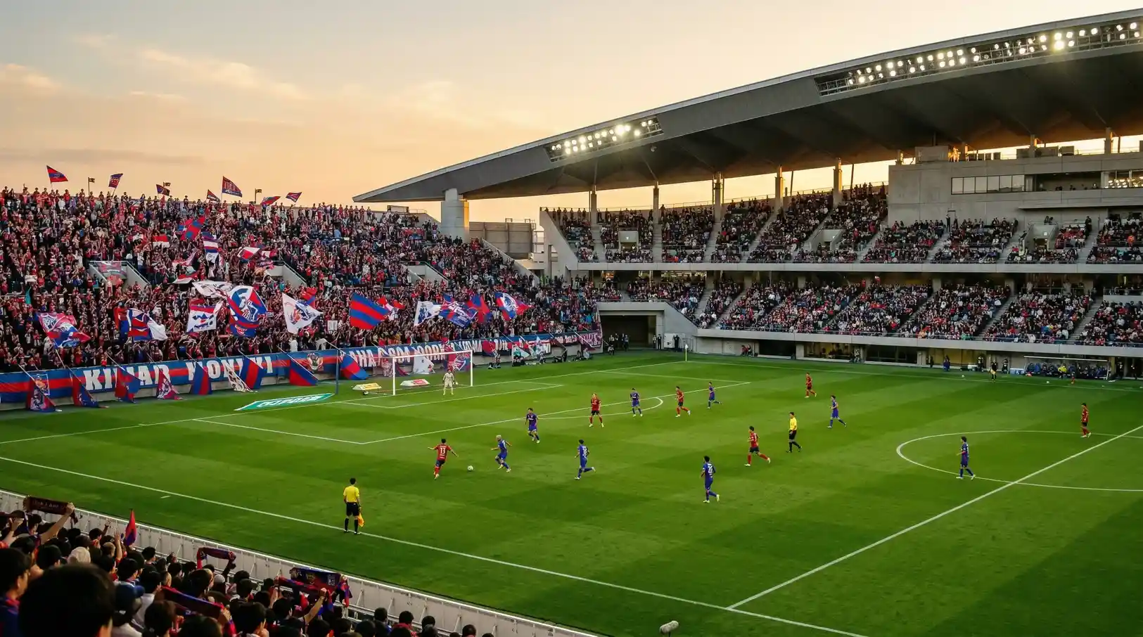 Estadio de fútbol japonés durante un partido de la J-League con aficionados animando